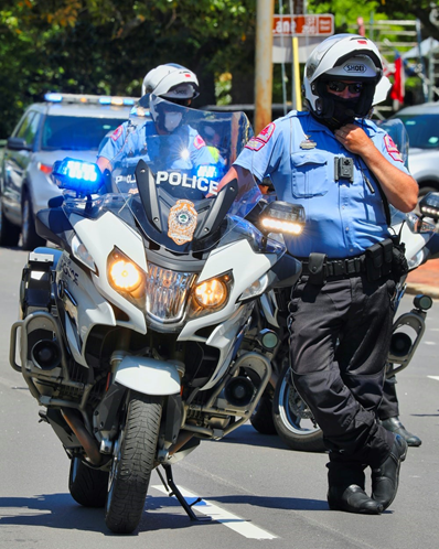 A police officer on a motorcycleDescription automatically generated with low confidence