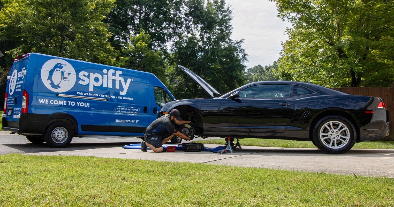 Spiffy technician performing mobile brakes service