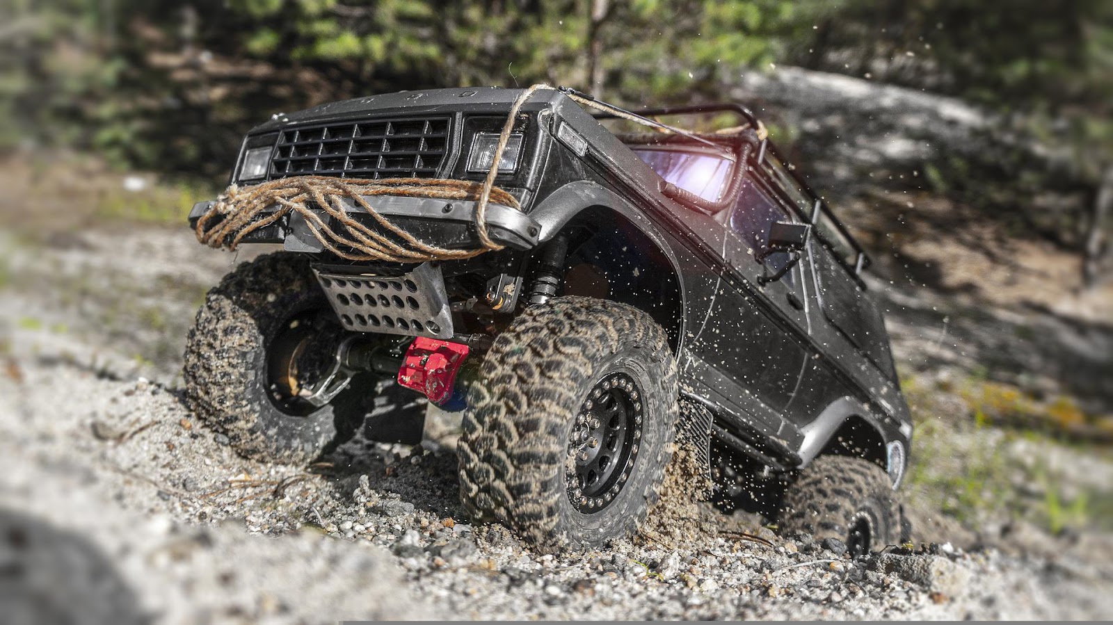 A picture of a Bronco offroading with a bunch of accessories on it similar to the ones sold by MbenzGram.